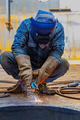 Welding male worker metal is part of machinery plate bottom tank sump construction