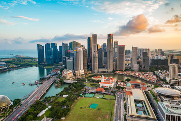 Aerial view of Singapore Marina Bay with iconic skyscrapers, Marina Bay Sands, and the financial district, symbolizing global economy, ESG, inflation impact, and sustainable growth.