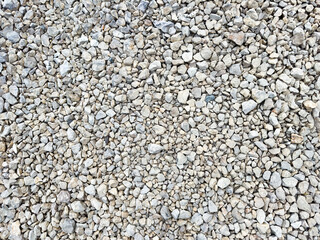 Gray gravel texture background with crushed stones and pebbles, seamless surface for architecture and design