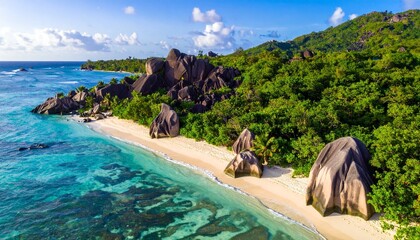 Tropical beach with granite boulders, turquoise water, and forested hills