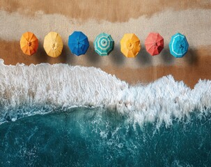 Colorful beach umbrellas lined up on the sand, aerial view