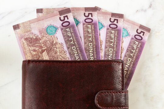 Jordan money. Jordanian 50-dinar bills sticking out of a wallet. Currency JOD. Business and financial concept.