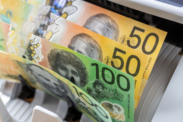 Australia money. Counting Australian dollars in a money counter. Financial and business concept. Currency AUD