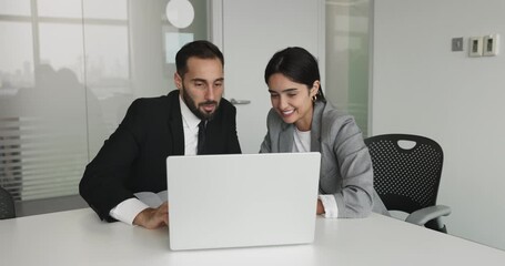 Two happy diverse business professional colleagues watching content - Powered by Adobe