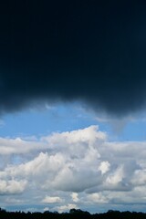 Fototapeta premium Clouds over the forest in summer