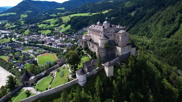 Austria tourism . greatest historic landmarks. impressive Hohenwerfen castle medieval fortress surrounded by Alps mountains. aerial 4k footage. Austrian market town of Werfen in the Salzach valley