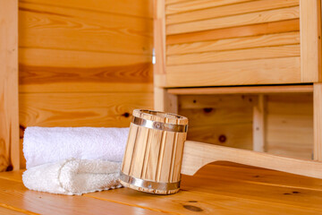 Detail of bucket and white towels in a sauna