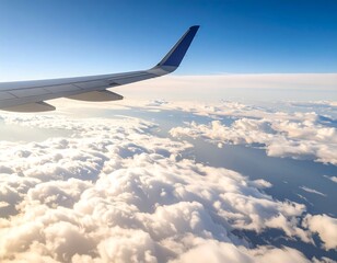 Fototapeta premium Airplane wing over fluffy clouds