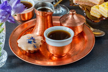 Coffee and selection of gourmet cakes set up on a table