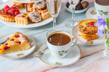 Coffee and selection of gourmet cakes set up on a table