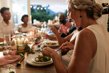 At wedding reception, guests sharing laughter and conversation during elegant dinner