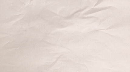 A textured, wrinkled piece of light-colored paper showcases subtle variations in tone, perfect for various art and craft activities. The soft, neutral backdrop enhances creativity