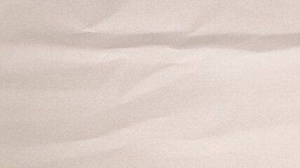 A close-up showcases crumpled paper with soft shadows and light reflections, creating an interesting texture in a tranquil environment, inviting observation and creativity