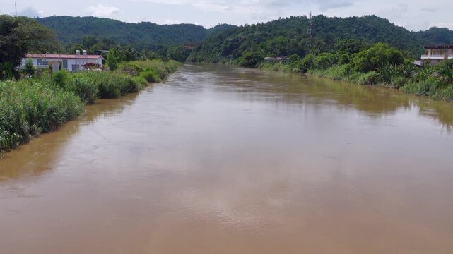 Regularly floods Padas River surrounded Bisaya-Brunei settlements, rainforest, tropical farming. View of Beaufort, Malaysia. Tropical city, heat and high humidity, monsoon season. Houses with veranda