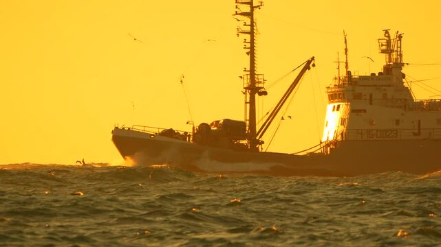Fishing trawler ocean, large boat sails waves golden sunset