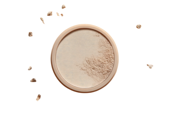 Light beige face powder in a round container, surrounded by scattered powder particles