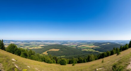 Naklejka premium Panoramic view from the top of a hill on a sunny day.
