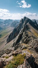 Majestic mountain peaks, sunlit ridges under a bright, partly cloudy sky