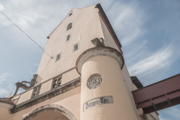 Innenseite des Stadttores Berger Tor , teilweise erbaut aus Suevit, in Nördlingen in Untersicht gegen blauen Himmel mit Schleierwolken © lebaer