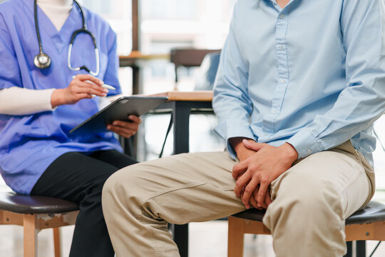 Young man holding groin in medical consultation testicular cancer awareness and concern
