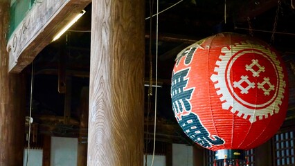 Closeup of large red Japanese paper lantern at a temple shrine