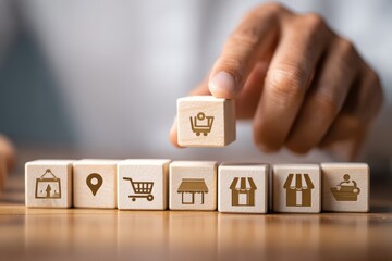 Wooden blocks with business icons being arranged