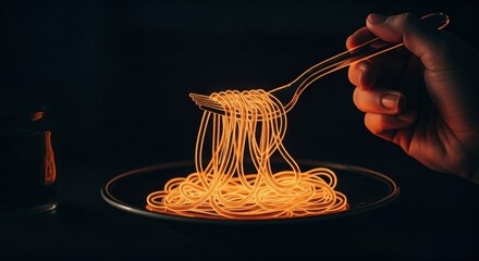 Hand holding fork with glowing orange spaghetti over dark plate pasta food