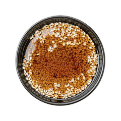 ginger soy sauce with sesame in black bowl top view isolated on white background