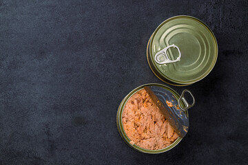 Canned tuna in brine isolated on black  background