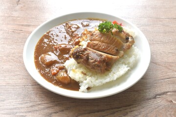 grilled slice chicken topping plain rice dressing potato and carrot in Japanese curry on plate 
