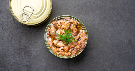 Canned tuna in brine isolated on black  background
