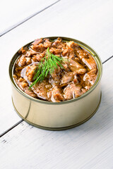 Canned tuna in brine isolated on white wooden background