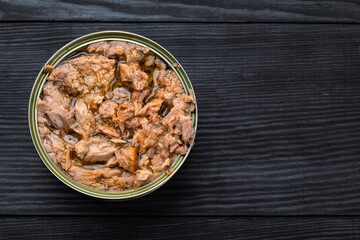 Canned tuna in brine isolated on white wooden background	

