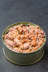 Canned tuna in brine isolated on black  background