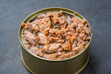 Canned tuna in brine isolated on black  background