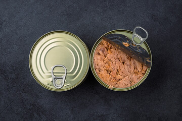 Canned tuna in brine isolated on black  background