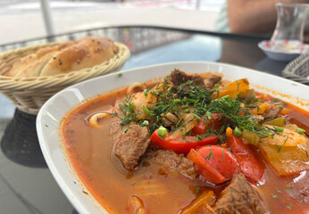 Chorba lamb soup, shurpa in Arabic restaurant. Kazakh meal with meat, spices and vegetables