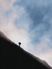 Abstract concept art of hiker silhouette climbing mountain ridge against dramatic sky, perfect for storytelling, posters, and branding use