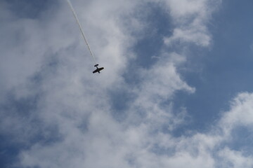 Solo Stunt Plane Soaring Through a Cloudy Sky