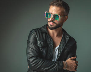 Fototapeta premium sexy fashion man with colorful squared sunglasses crossing arms