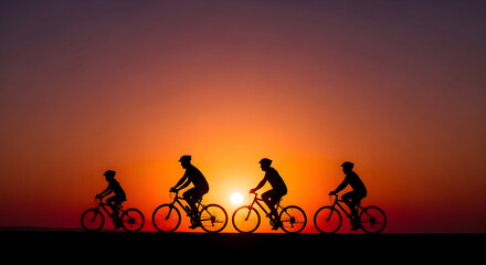 Silhouette of a group cycling against a vibrant sunset creating an inspirational scene showing