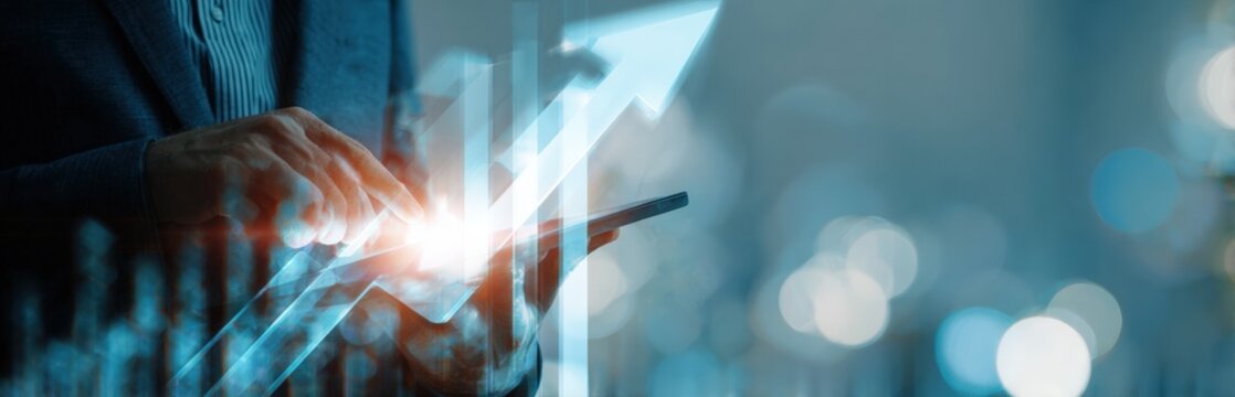 Businessperson interacting with a tablet displaying upward financial trends - Powered by Adobe