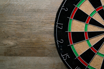 target dart board on the wooden table background, center point, head to target marketing and business success concept