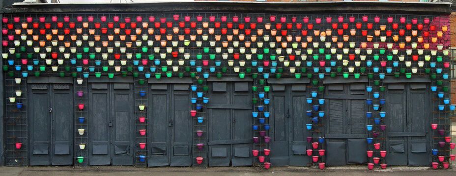 Colorful Flower Pots on Dark Wall &ndash; Urban Art Installation Background