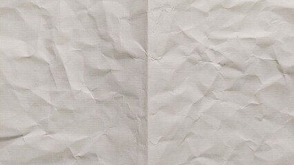 Obraz premium Crumpled and folded beige paper surface with wrinkled texture. Crumpled old beige paper texture with fold lines. Crumpled blank old beige paper folded in two fraction background. Ideal for backgrounds