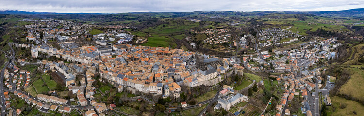 Aerial panoramic view around the old town and city Saint-Flour in France on a sunny afternoon