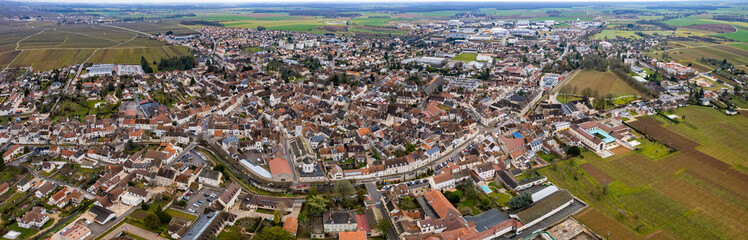 An aerial panoramic view around the old town of the city Nuits-Saint-Georges in France on a sunny day in early spring