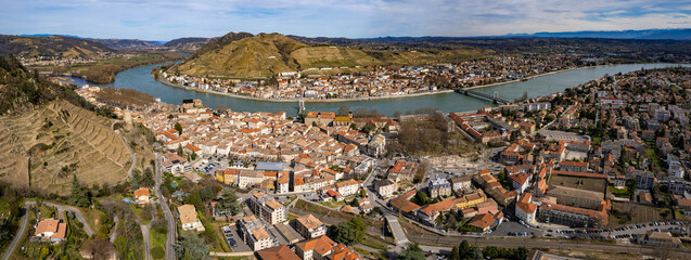 An aerial panoramic view around the old town of the city Tournon-sur-Rhône in France on a sunny day in early spring