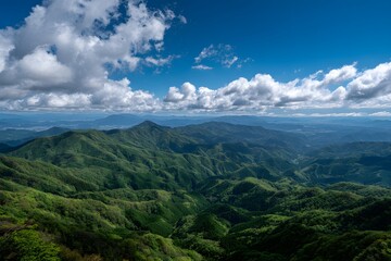 Naklejka premium Verdant mountain range under blue sky mountains green