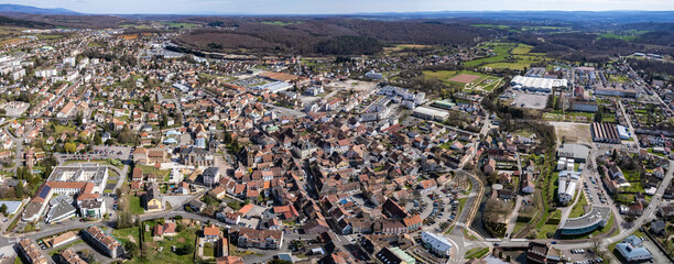 An aerial panoramic view around the old town of the city Héricourt in France on a sunny day in early spring
